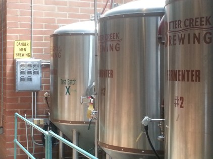 The sign next to the tanks at Bitter Creek Brewing make it very clear that important work is being done.